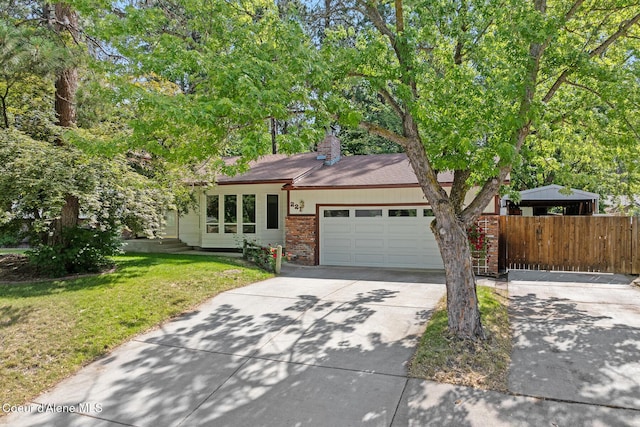 221 S Ridgewood Dr, Post Falls, ID 83854 - view of front of property with concrete driveway, a garage, brick siding, and a chimney