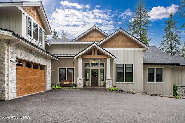 6767 S Renaissance Way, Coeur Dalene, ID 83814 - craftsman-style house featuring stone siding, a shingled roof, board and batten siding, and driveway