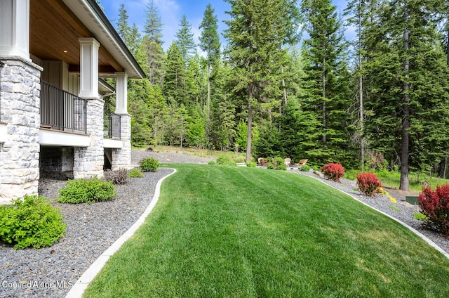 6767 S Renaissance Way, Coeur Dalene, ID 83814 - view of green lawn with a balcony and a wooded view