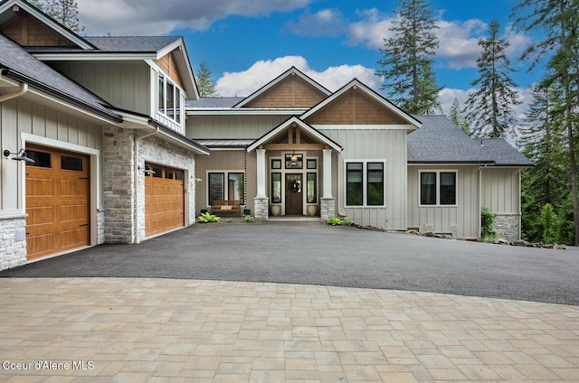 6767 S Renaissance Way, Coeur Dalene, ID 83814 - craftsman house featuring stone siding, board and batten siding, driveway, and roof with shingles