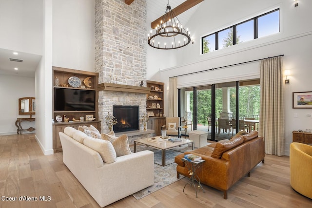 6767 S Renaissance Way, Coeur Dalene, ID 83814 - living area featuring high vaulted ceiling, light wood-style floors, a chandelier, beam ceiling, and a fireplace