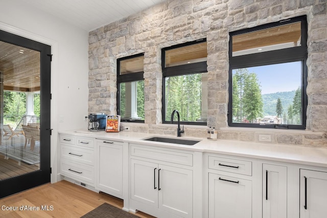 6767 S Renaissance Way, Coeur Dalene, ID 83814 - kitchen featuring white cabinetry, light countertops, and light wood-type flooring