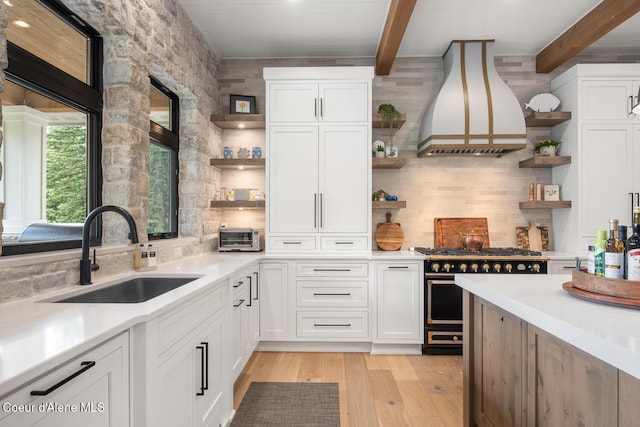 6767 S Renaissance Way, Coeur Dalene, ID 83814 - kitchen featuring open shelves, range with gas stovetop, custom range hood, beamed ceiling, and backsplash