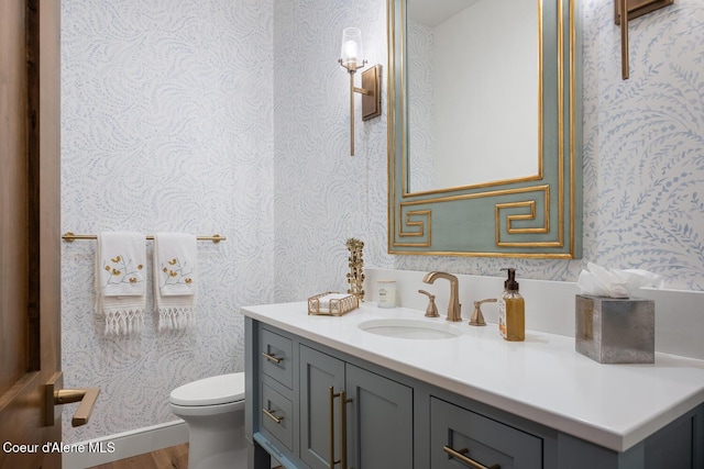 6767 S Renaissance Way, Coeur Dalene, ID 83814 - bathroom with wallpapered walls, vanity, and wood finished floors