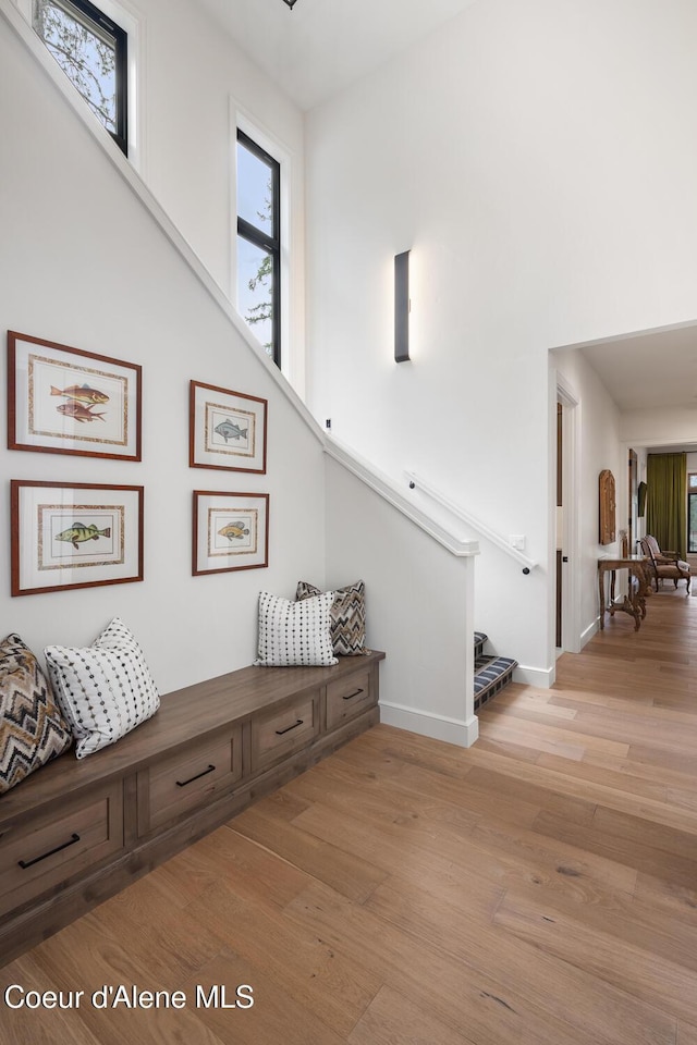 6767 S Renaissance Way, Coeur Dalene, ID 83814 - hall featuring stairs, light wood-style floors, and a towering ceiling