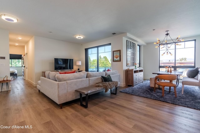115 E Lake St Unit 203, Sandpoint, ID 83864 - living room with light wood-type flooring, a chandelier, and baseboards