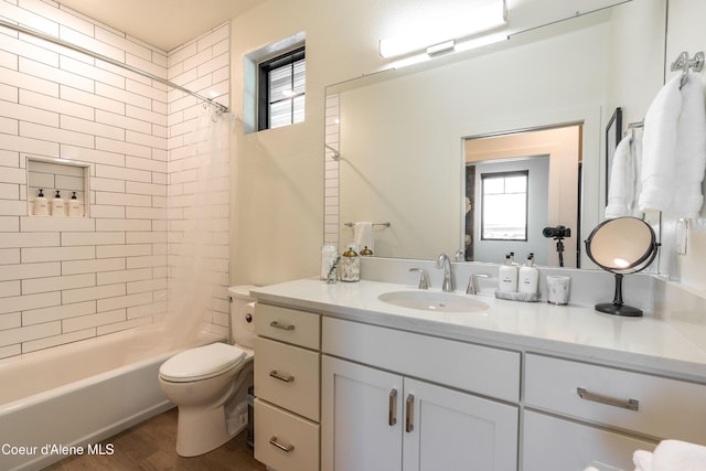 115 E Lake St Unit 203, Sandpoint, ID 83864 - full bathroom featuring toilet, vanity, healthy amount of natural light, and shower / bath combo