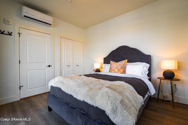 115 E Lake St Unit 203, Sandpoint, ID 83864 - bedroom featuring a wall mounted air conditioner, wood finished floors, a closet, and baseboards