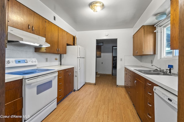 206 E 2nd Ave, Clark Fork, ID 83811 - kitchen with white appliances, under cabinet range hood, light wood finished floors, and light countertops