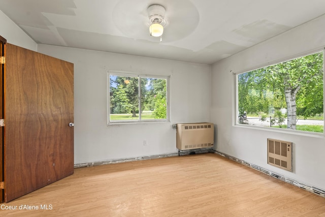 206 E 2nd Ave, Clark Fork, ID 83811 - spare room featuring light wood-type flooring, ceiling fan, and heating unit
