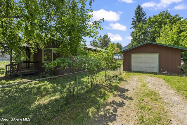 206 E 2nd Ave, Clark Fork, ID 83811 - view of yard featuring dirt driveway, an outdoor structure, and a detached garage