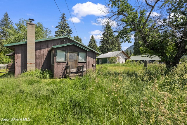 206 E 2nd Ave, Clark Fork, ID 83811 - back of house featuring a chimney