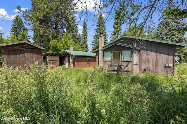 206 E 2nd Ave, Clark Fork, ID 83811 - rear view of property featuring a chimney