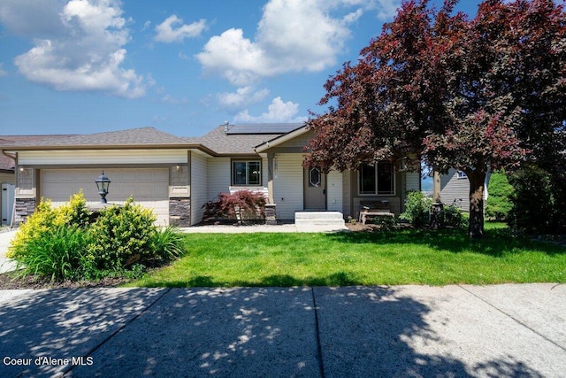 3551 N Carriage Ct, Post Falls, ID 83854 - view of front facade with a front lawn, an attached garage, solar panels, stone siding, and roof with shingles