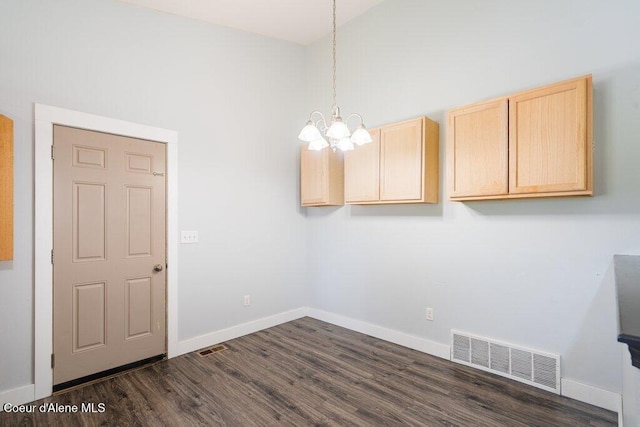 3551 N Carriage Ct, Post Falls, ID 83854 - unfurnished dining area with a chandelier, dark wood-style floors, and a high ceiling