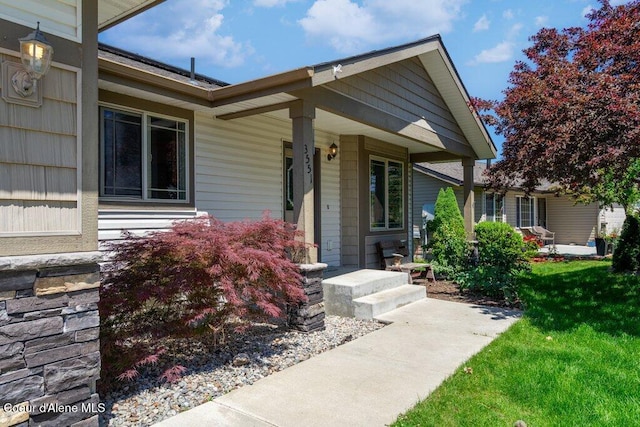 3551 N Carriage Ct, Post Falls, ID 83854 - doorway to property with a porch and a yard