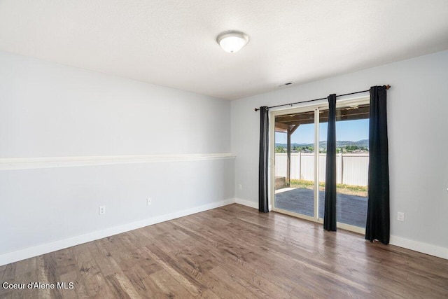 3551 N Carriage Ct, Post Falls, ID 83854 - unfurnished room featuring wood finished floors and a water view