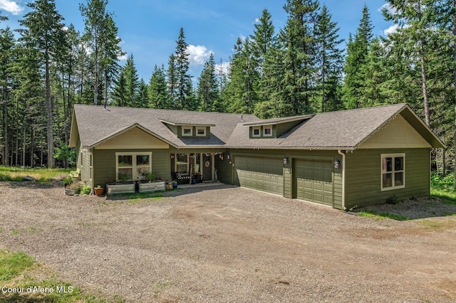 84 E Cabinet Wagon Rd, Clark Fork, ID 83811 - view of front facade featuring a garage, driveway, a shingled roof, and covered porch