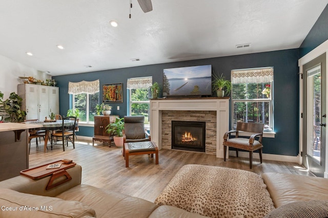 84 E Cabinet Wagon Rd, Clark Fork, ID 83811 - living area with wood finished floors, plenty of natural light, a fireplace, recessed lighting, and a ceiling fan