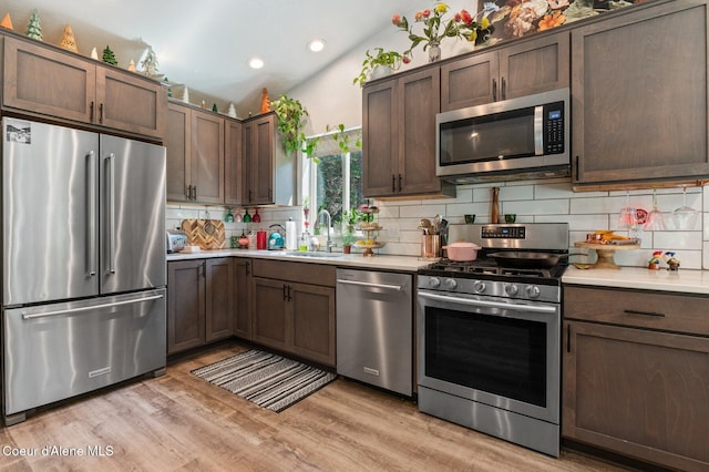 84 E Cabinet Wagon Rd, Clark Fork, ID 83811 - kitchen featuring appliances with stainless steel finishes, light countertops, recessed lighting, decorative backsplash, and light wood-style flooring