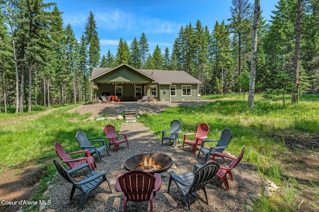 84 E Cabinet Wagon Rd, Clark Fork, ID 83811 - rear view of property featuring a fire pit and a patio area