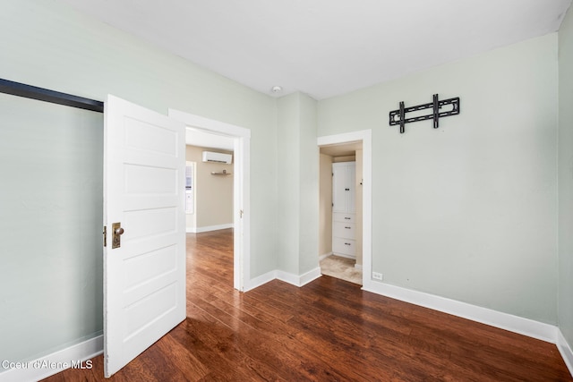 1215 N A St, Coeur Dalene, ID 83814 - empty room featuring an AC wall unit and dark wood-style floors