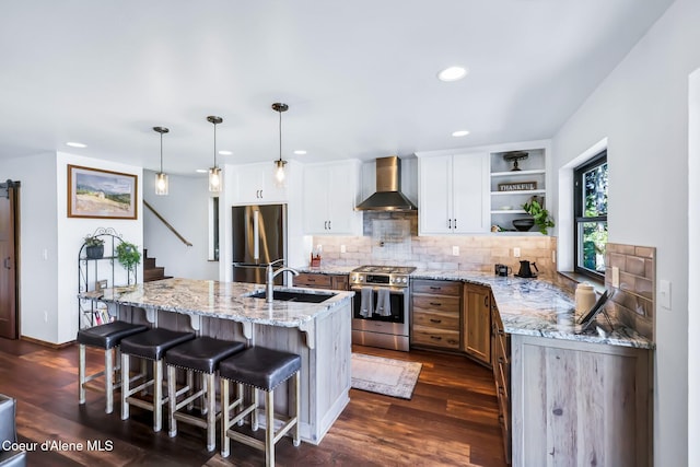 115 W Lakeview Blvd, Priest River, ID 83856 - kitchen with appliances with stainless steel finishes, wall chimney range hood, open shelves, decorative backsplash, and dark wood-style floors