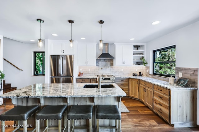 115 W Lakeview Blvd, Priest River, ID 83856 - kitchen with appliances with stainless steel finishes, wall chimney range hood, open shelves, tasteful backsplash, and dark wood-style flooring
