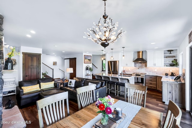 115 W Lakeview Blvd, Priest River, ID 83856 - dining room with dark wood finished floors, a chandelier, recessed lighting, and stairs