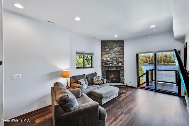 115 W Lakeview Blvd, Priest River, ID 83856 - living area with healthy amount of natural light, dark wood-style flooring, recessed lighting, and a stone fireplace