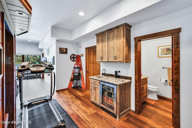 115 W Lakeview Blvd, Priest River, ID 83856 - kitchen featuring wine cooler, dark wood-style flooring, light stone countertops, and recessed lighting