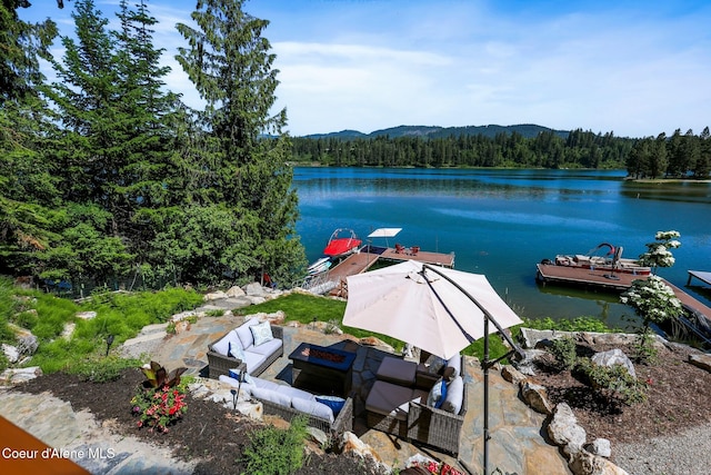 115 W Lakeview Blvd, Priest River, ID 83856 - dock area featuring a wooded view, an outdoor living space with a fire pit, a water view, and a patio area