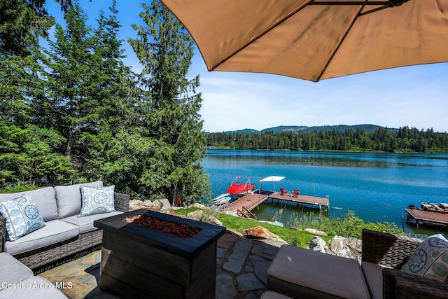 115 W Lakeview Blvd, Priest River, ID 83856 - view of patio with a forest view, a water and mountain view, an outdoor living space with a fire pit, and a dock