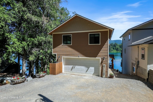 115 W Lakeview Blvd, Priest River, ID 83856 - view of front of home with driveway, a garage, and a water view
