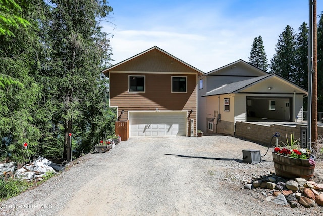 115 W Lakeview Blvd, Priest River, ID 83856 - view of front of property featuring gravel driveway and an attached garage