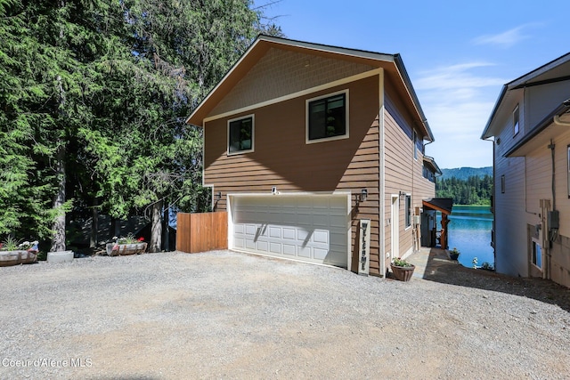 115 W Lakeview Blvd, Priest River, ID 83856 - view of side of property featuring gravel driveway and an attached garage