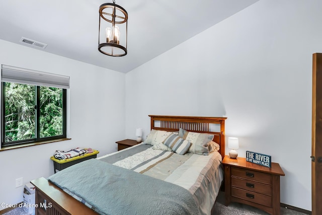 115 W Lakeview Blvd, Priest River, ID 83856 - bedroom with carpet floors and a chandelier