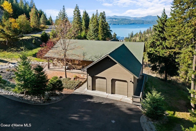 3889 E Avery Ln, Coeur Dalene, ID 83814 - view of front of house with a garage, driveway, and a water and mountain view