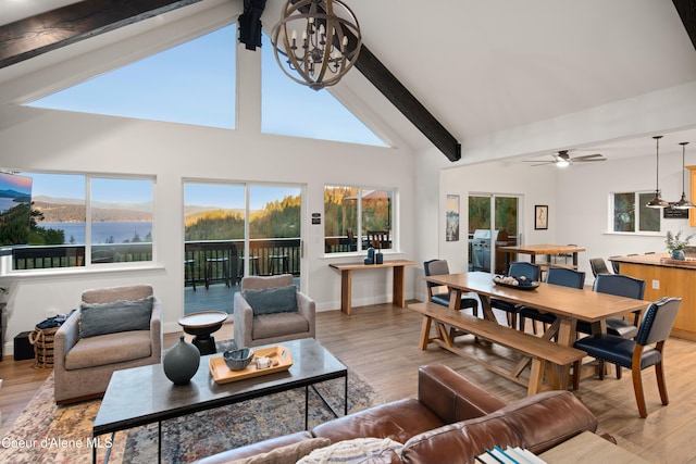 3889 E Avery Ln, Coeur Dalene, ID 83814 - living room featuring beamed ceiling, a chandelier, wood finished floors, ceiling fan, and high vaulted ceiling