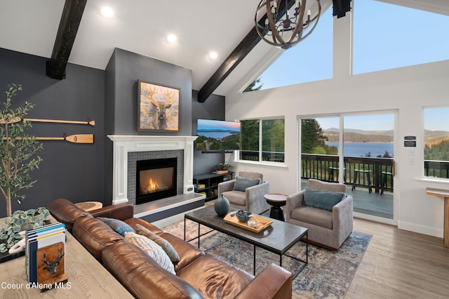 3889 E Avery Ln, Coeur Dalene, ID 83814 - living area with beam ceiling, wood finished floors, a fireplace, high vaulted ceiling, and recessed lighting