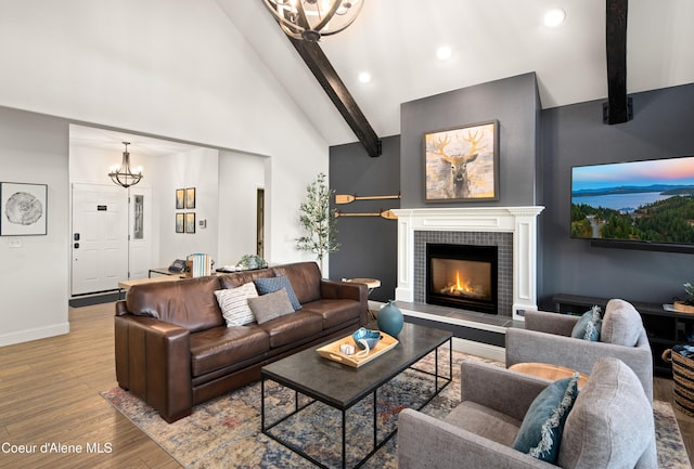 3889 E Avery Ln, Coeur Dalene, ID 83814 - living area featuring beam ceiling, a chandelier, wood finished floors, recessed lighting, and a tiled fireplace