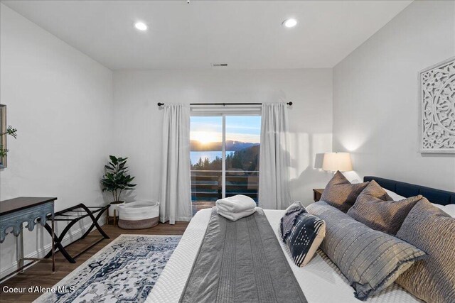 3889 E Avery Ln, Coeur Dalene, ID 83814 - bedroom with wood finished floors, recessed lighting, and access to exterior