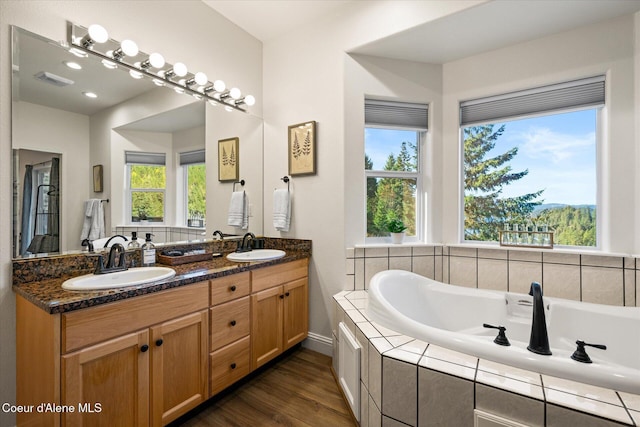 3889 E Avery Ln, Coeur Dalene, ID 83814 - full bath featuring double vanity, plenty of natural light, wood finished floors, and a garden tub
