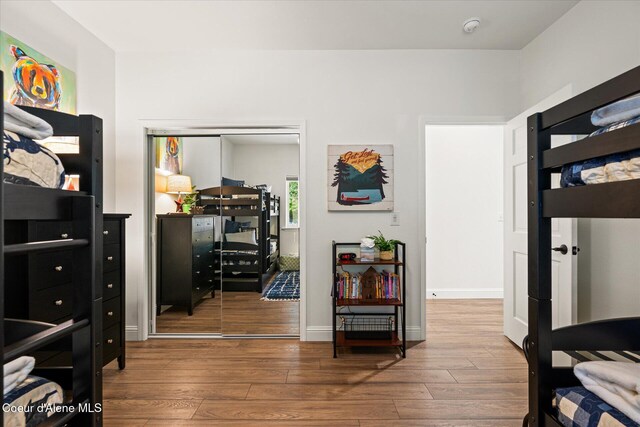 3889 E Avery Ln, Coeur Dalene, ID 83814 - bedroom featuring wood finished floors and a closet