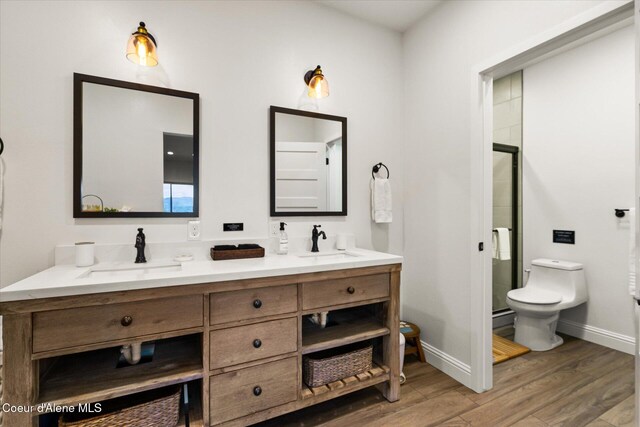 3889 E Avery Ln, Coeur Dalene, ID 83814 - full bathroom featuring wood finished floors, double vanity, a shower stall, and a baseboard heating unit