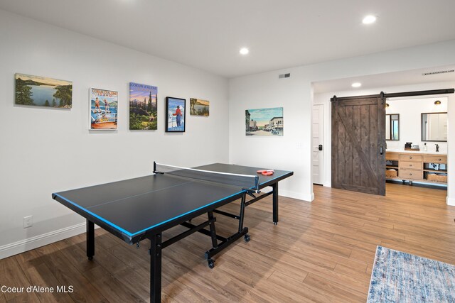 3889 E Avery Ln, Coeur Dalene, ID 83814 - playroom with a barn door, recessed lighting, and light wood-style flooring