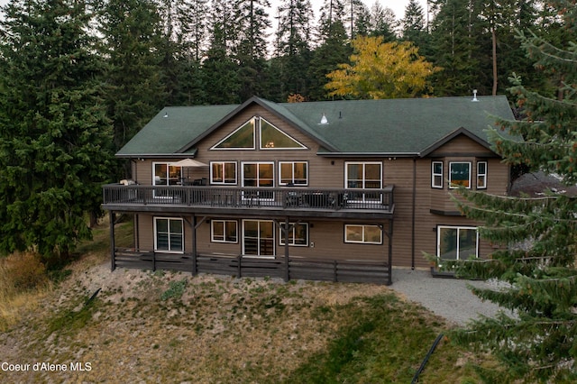 3889 E Avery Ln, Coeur Dalene, ID 83814 - back of property with a wooden deck and a shingled roof