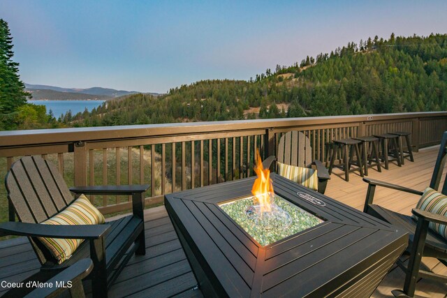 3889 E Avery Ln, Coeur Dalene, ID 83814 - wooden terrace with a fire pit, a wooded view, and a water and mountain view