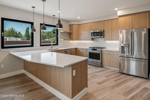 503 Cedar St # 203, Sandpoint, ID 83864 - kitchen with stainless steel appliances, a peninsula, open shelves, light countertops, and tasteful backsplash