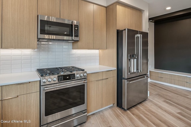 503 Cedar St # 203, Sandpoint, ID 83864 - kitchen featuring appliances with stainless steel finishes, light countertops, light wood-style flooring, modern cabinets, and recessed lighting